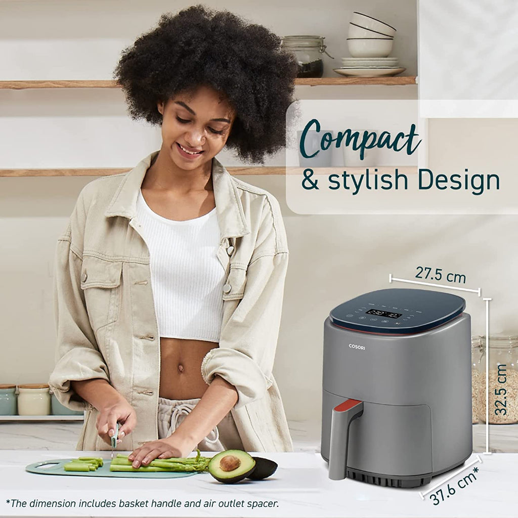 Compact air fryer on countertop with top control panel and side handle