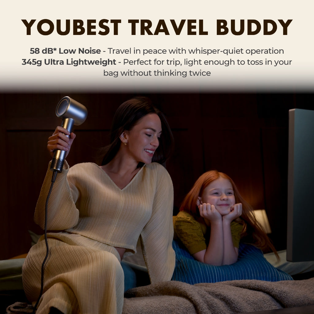 Gold travel hair dryer held by person while drying hair beside a child