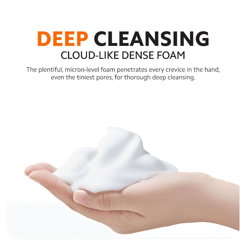 Hand holding dense white foam, automatic soap dispenser dispensing