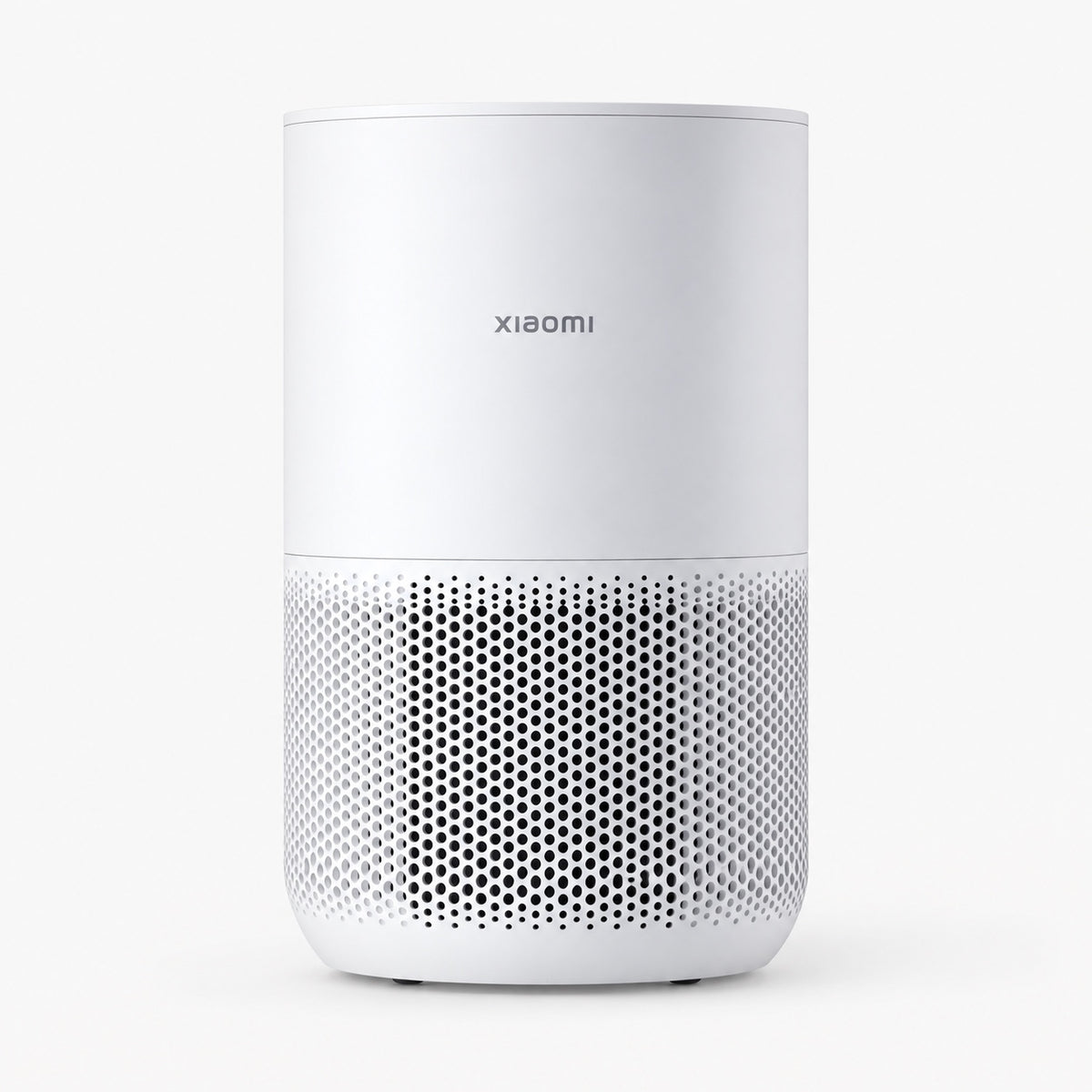 White compact air purifier with front perforated grille and top control panel.