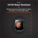 Black square smartwatch with orange time and date on the display
