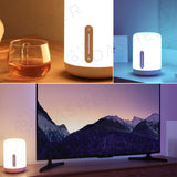 White bedside lamp with brown vertical control strip, multi-angle view