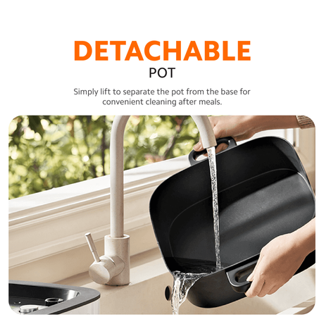 Multifunction hot pot cooker with detachable black pot being lifted from the base
