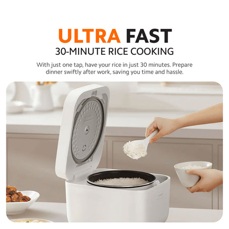 Multifunctional rice cooker with open lid and inner pot, hands adding rice