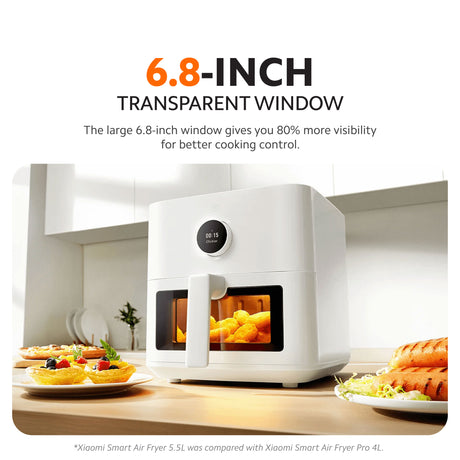 Air fryer with large transparent window and front handle, food visible inside.