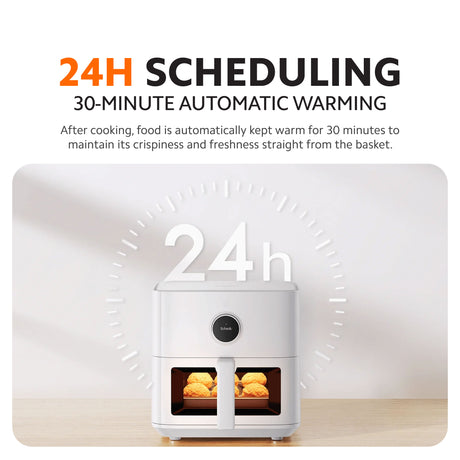 Air fryer showing 24-hour scheduling and warm-holding indicator with basket food.