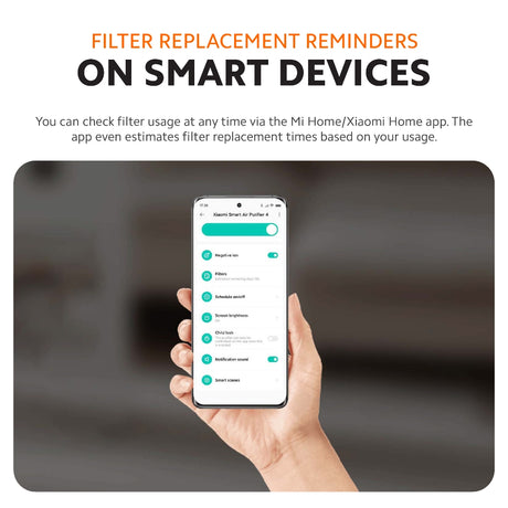 Air filter replacement reminder shown on a smartphone next to a filter