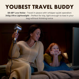 Gold travel hair dryer held by person while drying hair beside a child