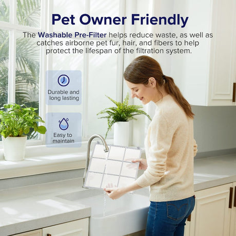Washable pre-filter frame for a Levoit pet air purifier, held above a sink
