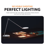 LED desk lamp with extended arms and round base, illuminating a workspace evenly