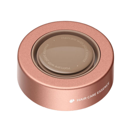 Rose-gold circular hair care nozzle cap with recessed center