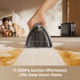 Steam spot cleaner applying steam to a carpet stain with metal tool head