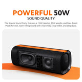 Black cylindrical Bluetooth speaker with orange trim, front driver and bass ports
