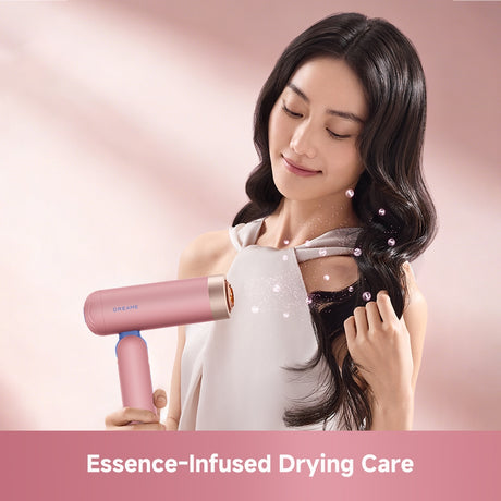 Pink pocket hair dryer with concentrator nozzle during hair drying