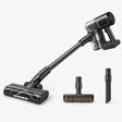 Black cordless stick vacuum with clear dust bin and floor brush, plus two attachments
