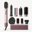 Rose gold hair styler set with multiple attachments, including brush, barrels, and diffuser