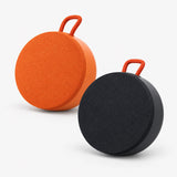 Mini outdoor Bluetooth speaker, round mesh body with orange handle, orange and black pair