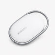 Oval Bluetooth tracker tag with gray metal ring and white back, Xiaomi logo on surface