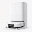 White robot vacuum docked in a self-cleaning charging base
