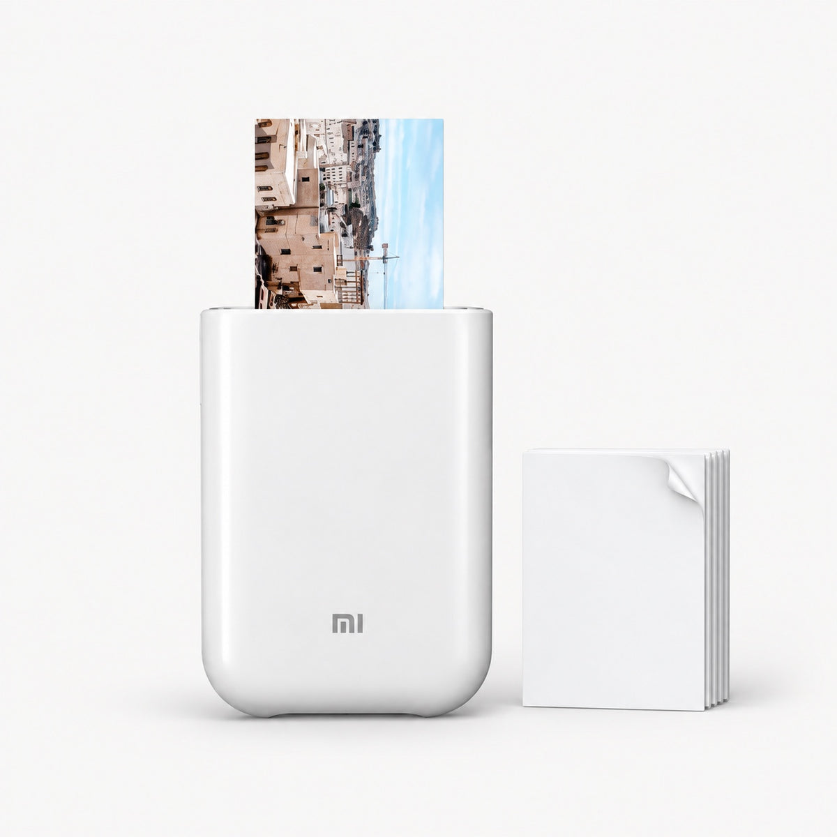 White pocket photo printer with photo sheet and stacked ZINK film
