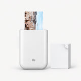 White pocket photo printer with photo sheet and stacked ZINK film