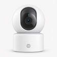 White indoor security camera with rotating lens on a round base