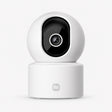 Indoor security camera with white dome body and black circular lens housing