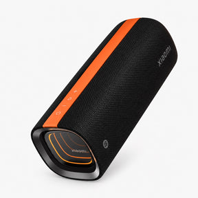 Black cylindrical Bluetooth speaker with orange side stripe and front grille