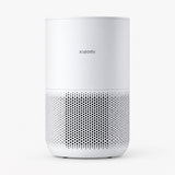 White compact air purifier with front perforated grille and top control panel.