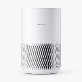 White compact air purifier with front perforated grille and top control panel.