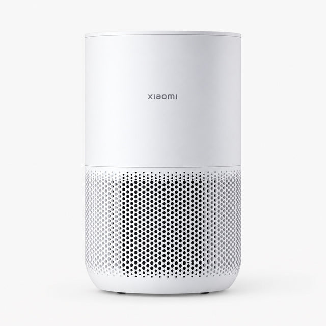 White compact air purifier with front perforated grille and top control panel.