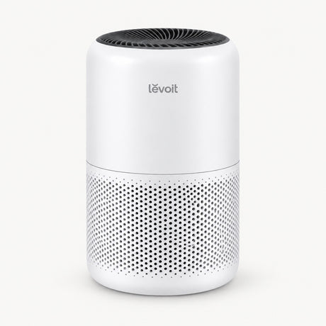 White Levoit air purifier with perforated lower panel and black top vent grille.