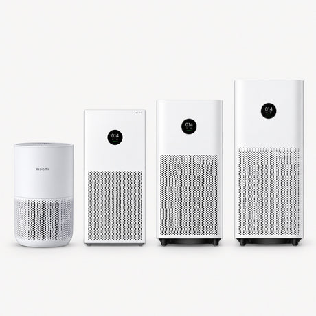 Set of four Xiaomi air purifiers, white cylindrical units with top control displays